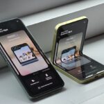 Two cell phones sitting next to each other on a window sill