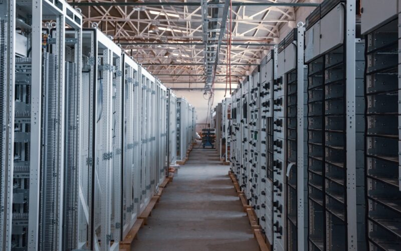 server room aisle with metal equipment racks