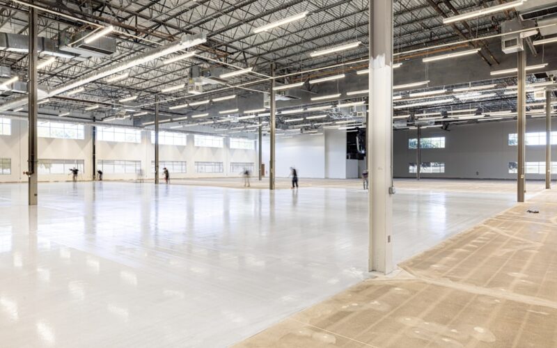 Empty, modern warehouse interior with polished concrete floor.