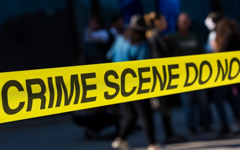 Geofence warrants — a group of people standing next to a yellow police line