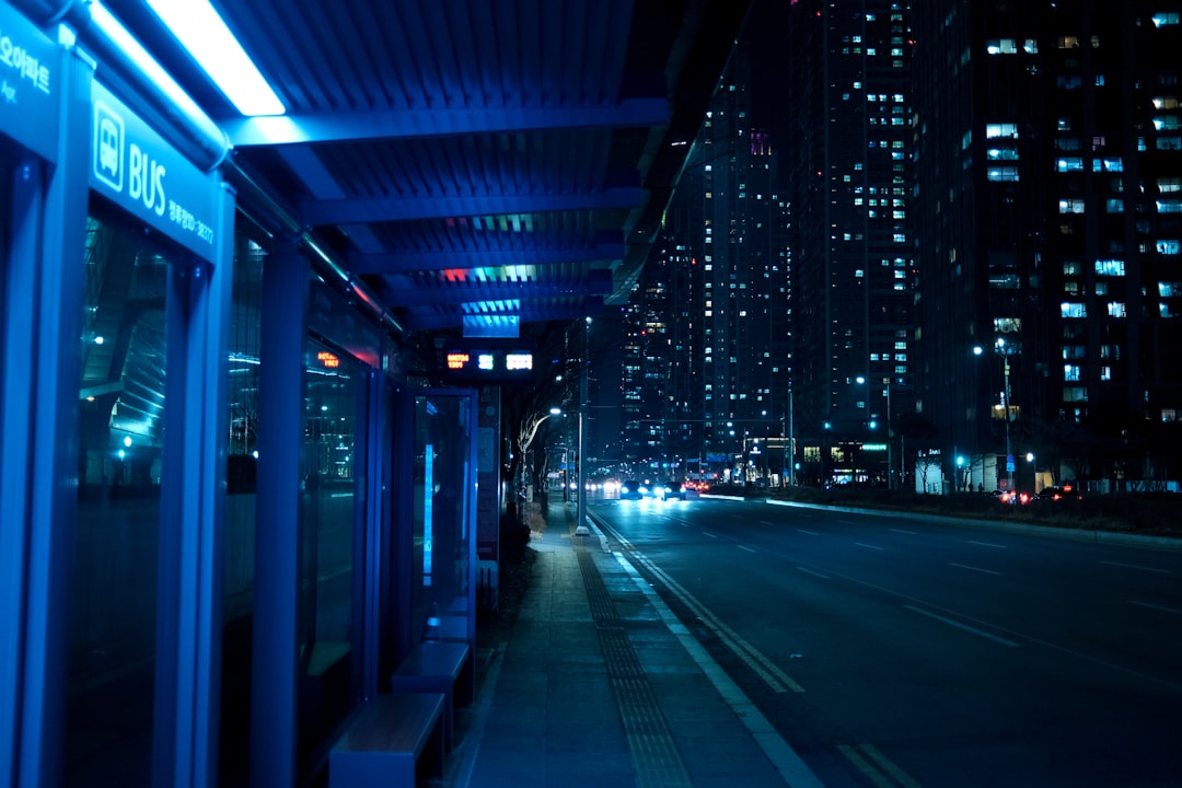 a city street at night with buildings lit up