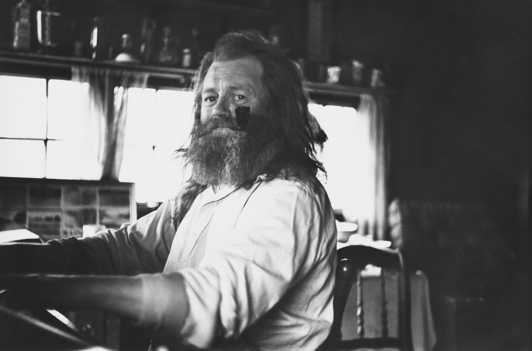 Bearded man in a room with windows