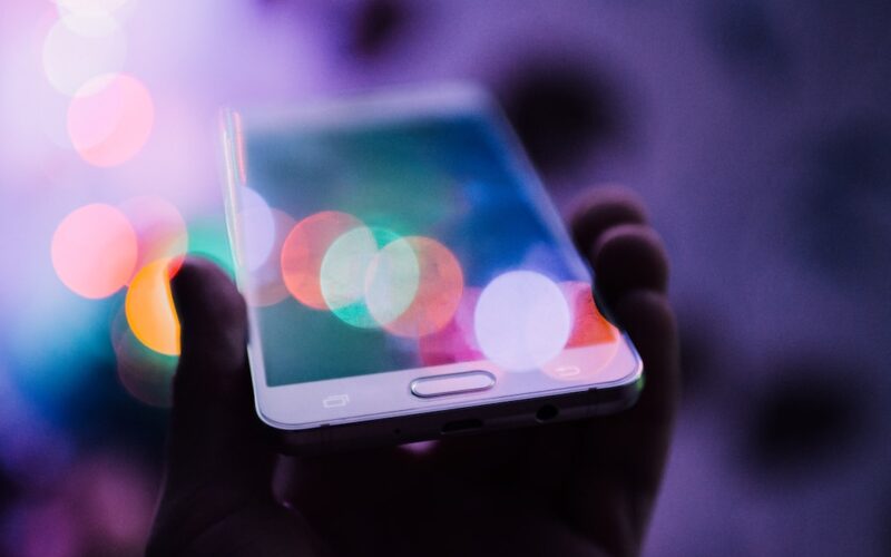 Pegasus spyware accountability — person holding smartphone