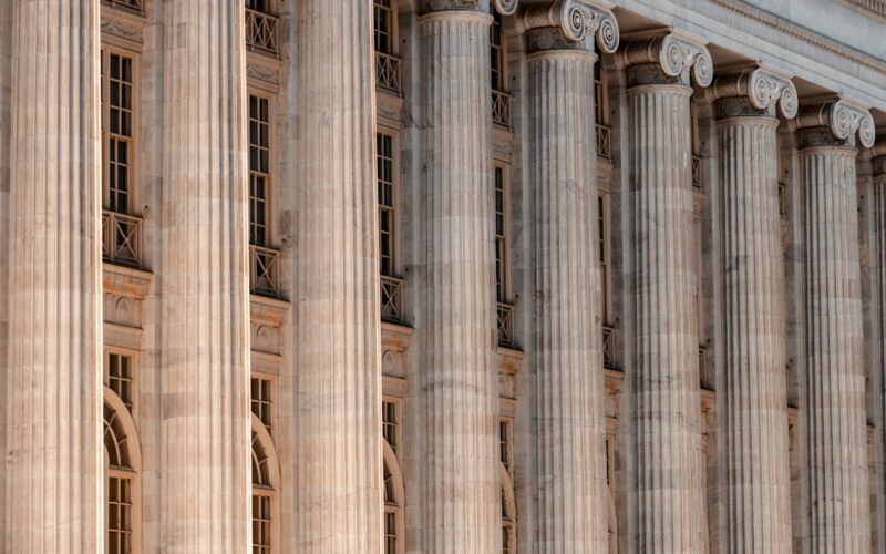 State antitrust enforcement — a large building with columns and a clock on the front of it