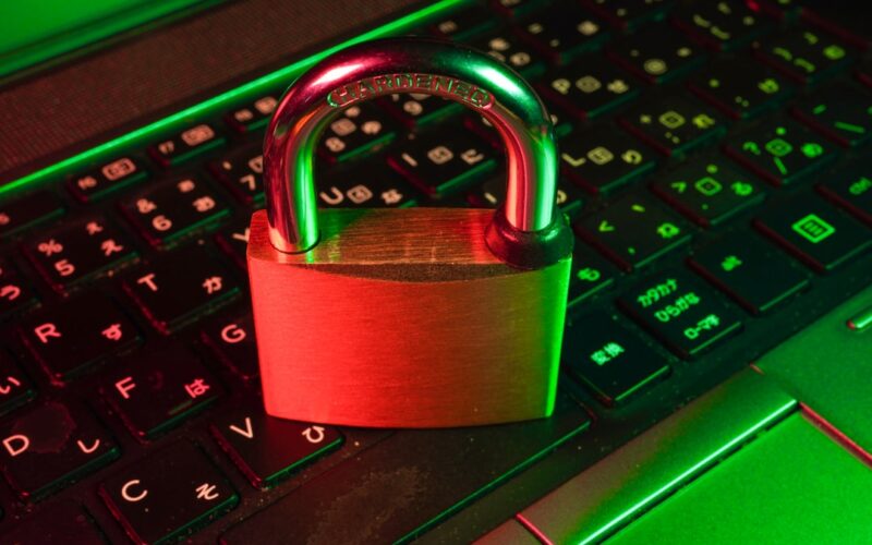 Macos screen sharing exploit — red padlock on black computer keyboard