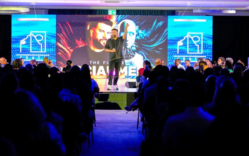 Ai ceo political alignment — speaker presenting on stage to an audience